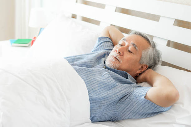 istock Senior man Suffering in bed cannot sleep from insomnia , Senior male , old man sleeping on bed in the morning - senior insomnia problem concept 1329071870