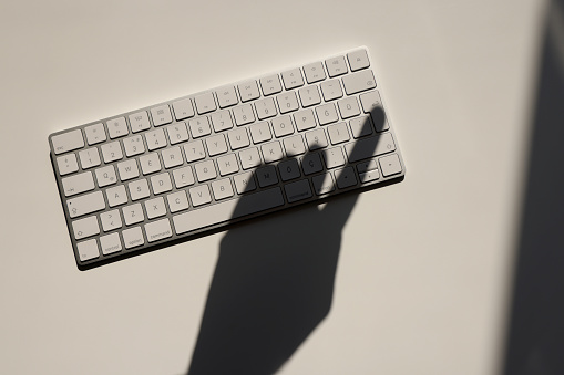 Computer keyboard with hand shadow