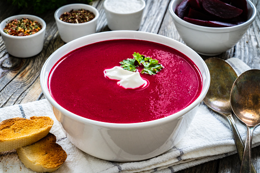 Cream beetroot soup on wooden table