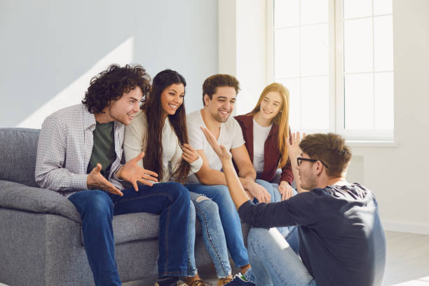 istock A group of friends talking in a room. 1329081578