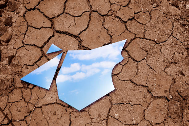 blue sky reflected in the mirror breaking up on cracked soils. arid climate change concept. - the natural world plant attribute natural phenomenon mineral imagens e fotografias de stock
