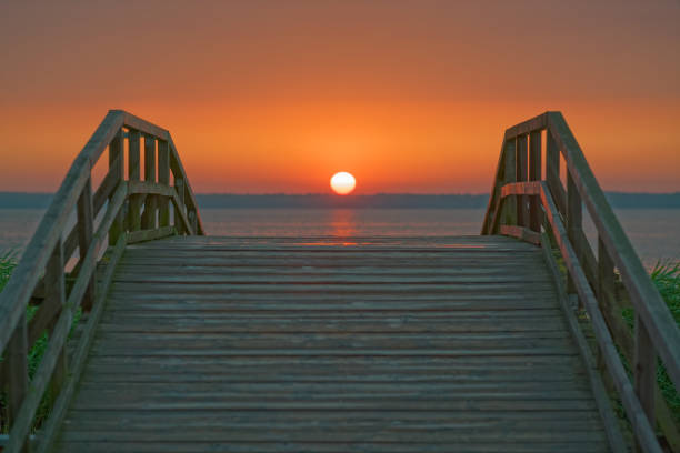 istock Sunset over wooden Bridge  at lake 1329083989