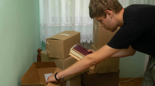 istock Student moving in to his dorm, starting his student life, entering his room with boxes, arranging his stuff. 1329084088