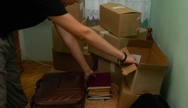 istock Student moving in to his dorm, starting his student life, entering his room with boxes, arranging his stuff. 1329084098