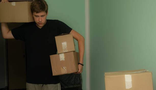 istock Student moving in to his dorm, starting his student life, entering his room with boxes, arranging his stuff. 1329084151