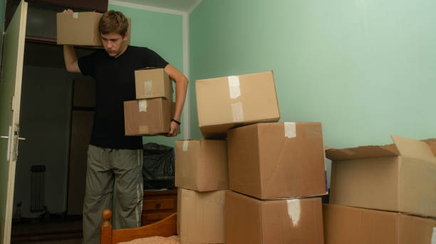 istock Student moving in to his dorm, starting his student life, entering his room with boxes, arranging his stuff. 1329084157