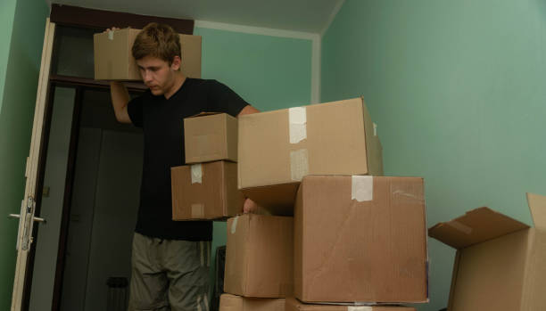 istock Student moving in to his dorm, starting his student life, entering his room with boxes, arranging his stuff. 1329084178