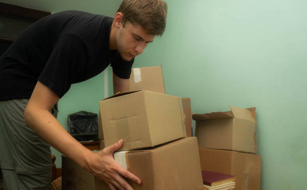 istock Student moving in to his dorm, starting his student life, entering his room with boxes, arranging his stuff. 1329084237