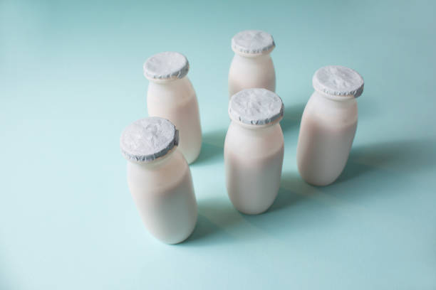 istock Bottles with probiotics and prebiotics dairy drink on light blue background. 1329085903