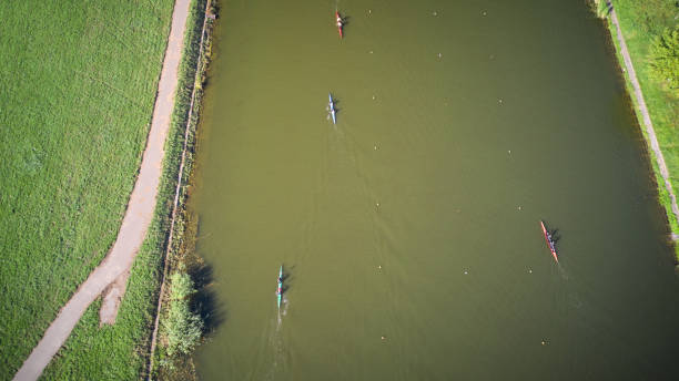 aerial of the rowing canal and boats rowing through the water - rowboat sport rowing team sports race imagens e fotografias de stock