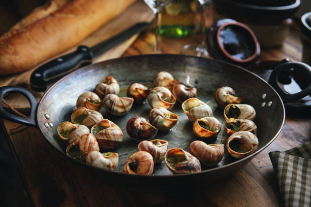 istock Preparing French Escargot Snails with Herb Butter 1329092400