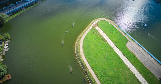 rowing canal and boats rowing through the water aerial view - rowboat sport rowing team sports race imagens e fotografias de stock