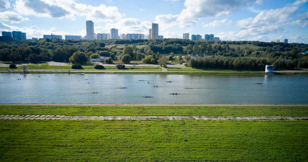 rowing canal with boats sculling across - rowboat sport rowing team sports race imagens e fotografias de stock