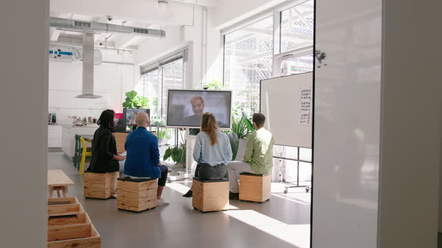 Staff meeting in hybrid office space via video call