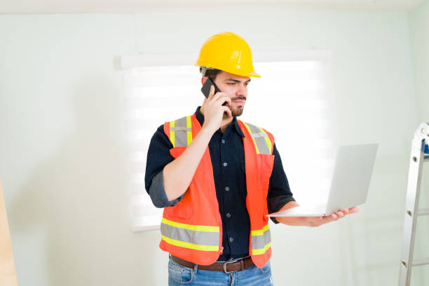istock Contractor talking on the phone with a customer 1329096063