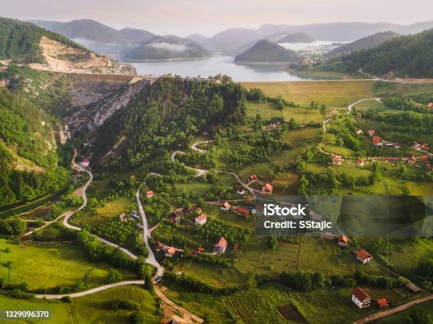 Tranquil View Of Remote Mountain Village With Lake In Misty Summer Morning Nature Outdoors Travel Destination National Park Tara Zaovine Lake Serbia Stock Photo - Download Image Now