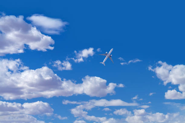 Sky with clouds with a airplane flying upward