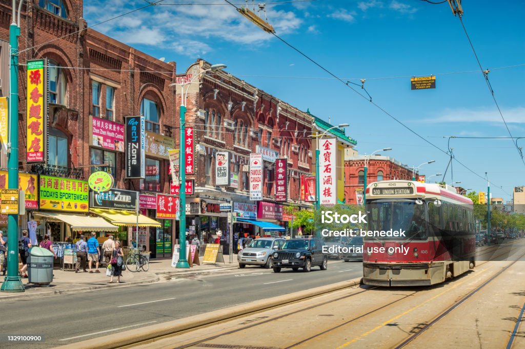 Chinatown downtown Toronto Canada Streetcar and people move along Spadina Avenue in Chinatown, downtown Toronto, Ontario, Canada on a sunny day. Toronto Stock Photo