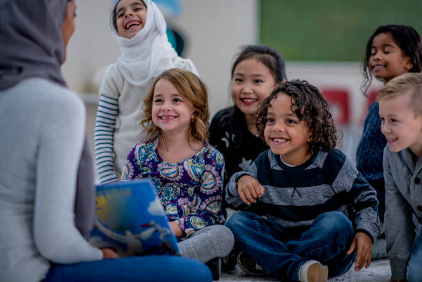 istock Kids sitting on the classroom carpet 1329100917