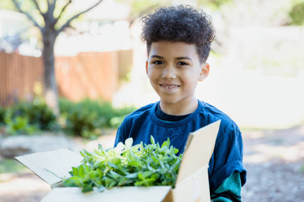istock Elementary age boy shows off harvest of herbs 1329102013