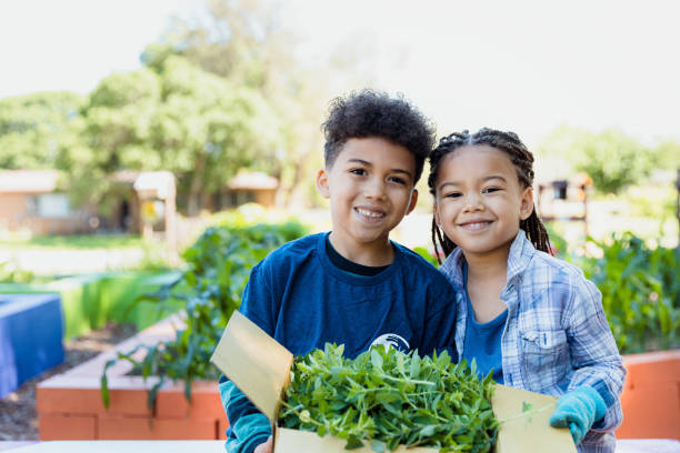 istock Elementary age students on field trip hold box of herbs 1329102015