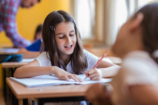istock Cheerful girl taking notes at classroom 1329102083