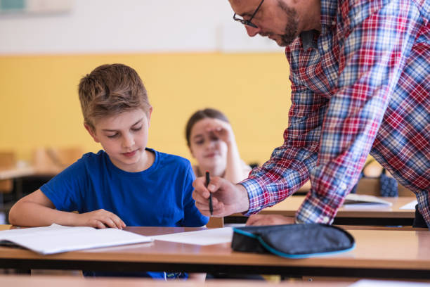 istock Boy looking at the paper teacher is grading 1329102150