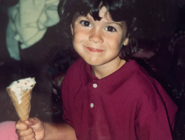 istock Little Girl Holding Ice Cream Cone 1990s 1329103072