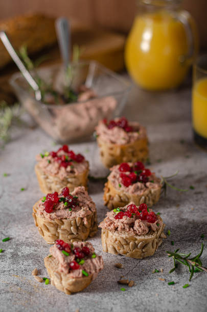 Homemade pate on heathy bread with cranberries Delicious homemade pate with wholegrain pastry and herbs heathy snack stock pictures, royalty-free photos & images