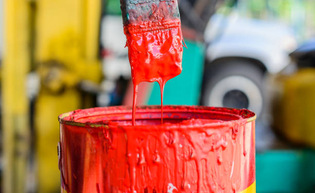 istock Technician maintenance testing color mixing by using old brush dip and check oil paint drip down in paint cans. 1329107682