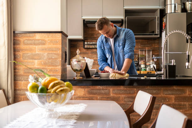 istock Man preparing food. Cooking at home. 1329107781