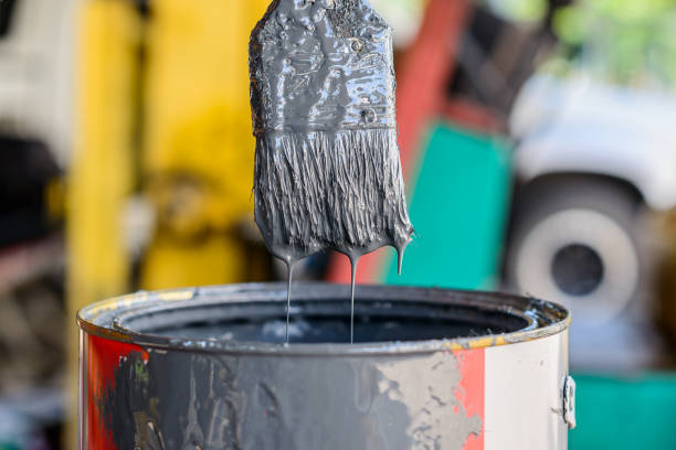 istock Technician maintenance testing color mixing by using old brush dip and check oil paint drip down in paint cans. 1329108553