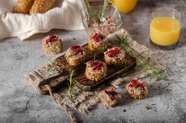 Homemade pate on heathy bread with cranberries Delicious homemade pate with wholegrain pastry and herbs heathy snack stock pictures, royalty-free photos & images