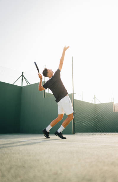 istock Paddle tennis player servicing ball in the air 1329108963