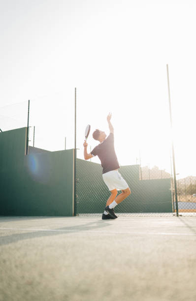 istock Paddle tennis player servicing ball in the air 1329108974