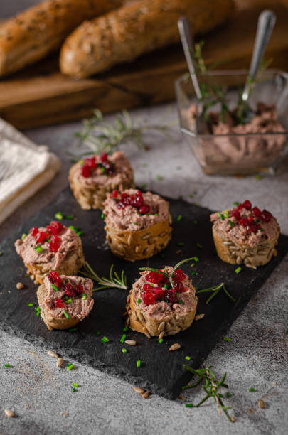Homemade pate on heathy bread with cranberries Delicious homemade pate with wholegrain pastry and herbs heathy snack stock pictures, royalty-free photos & images