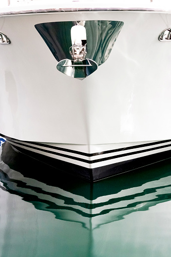 Closeup bow of luxury yacht with anchor, background with copy space, vertical composition