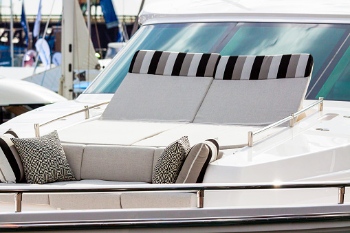 Closeup luxury yacht with deck seats, background with copy space, vertical composition