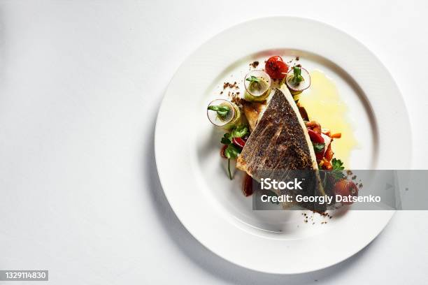 Grilled Seabass With Vegetables Top View Closeup White Plate Light Background Copy Space Stock Photo - Download Image Now