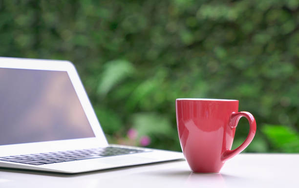 istock Good morning with coffee in red cup with computer laptop. 1329116538