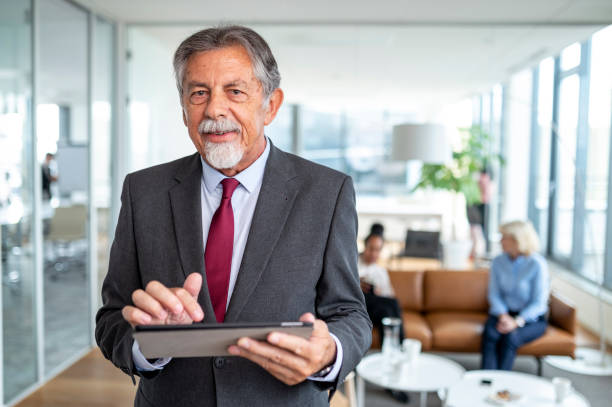 istock Portrait of Male Executive in 70s Using Digital Tablet 1329123349
