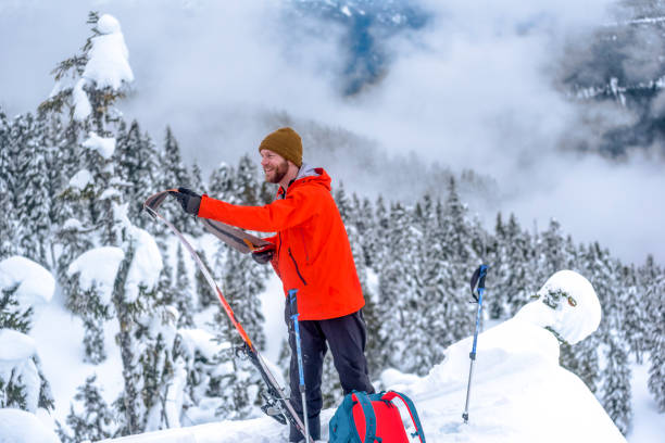istock Backcountry skier prepares for descent in snowy forest 1329123653