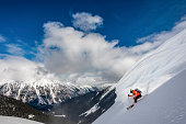 Backcountry skier descends snow slope