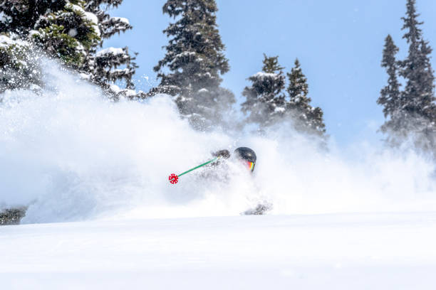 istock Backcountry skier descends through dense powder 1329128233