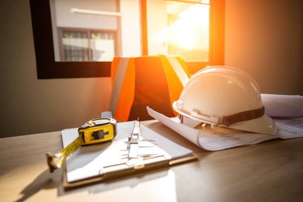 istock Working tools Engineer office desk with helmet at desk talbe 1329128878