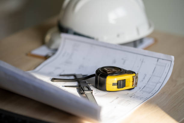 istock Working tools Engineer office desk with helmet at desk talbe 1329128915