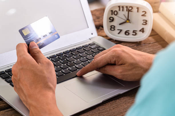 istock People use credit cards to shop online through notebook computers. 1329132818