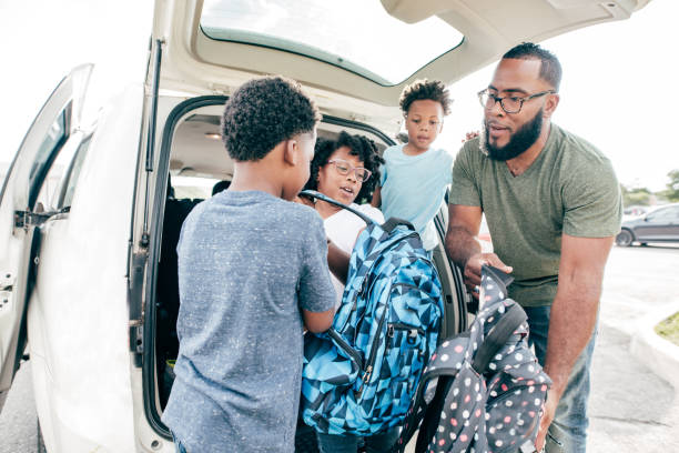 istock Dad helping kids go to school by car 1329134351