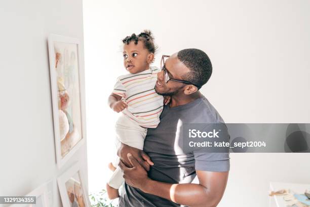 Fun Learning Activities For 1yearolds Dad Showing New Pictures To His Baby Daughter Stock Photo - Download Image Now