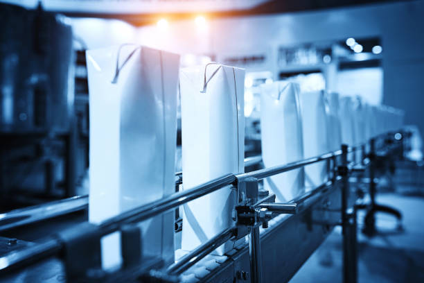 Side view of blank milk carton at production line.
